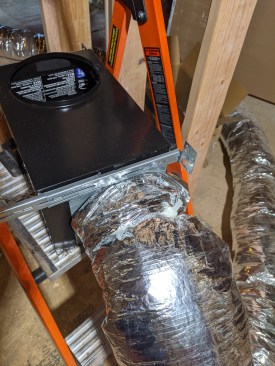 ... He then  pulls up the insulation and secures it with the zip tie.