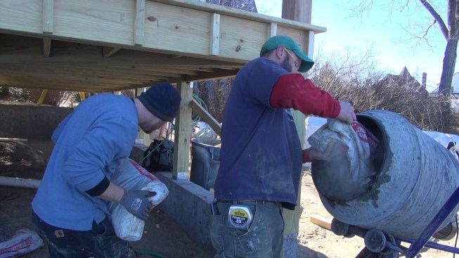 Chris and Shane mix a batch of concrete for their new Sonotube piers.