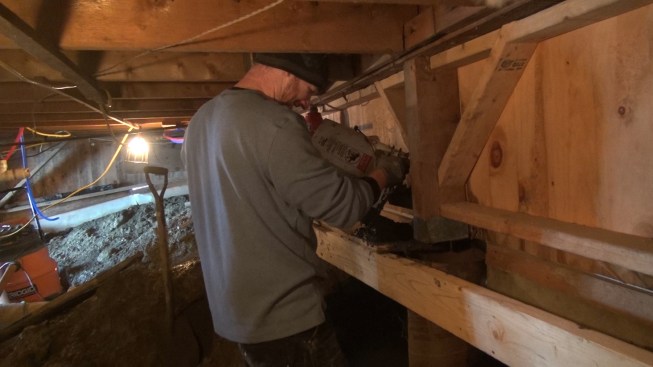 Chris dumps a bucket of concrete into the Sonotube.