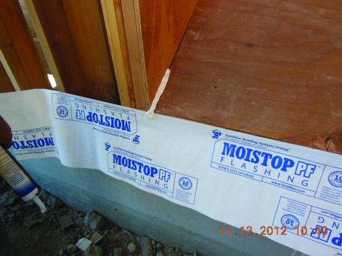Flashing a deep window recess. Start by applying the sill apron across the outside face of the wall, and caulk the corner of the recess.