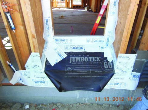 The author always installs a protective layer of black paper to ward off damage to the bottom of the recess during construction. A final sill membrane flashing is applied over the black paper below the window opening.
