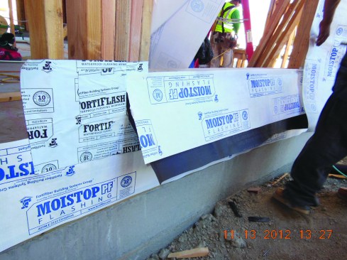 Black paper is installed as a protective layer over the horizontal surface of the recess, and a final membrane “apron” to tie in with the WRB is installed on the face of the framing.