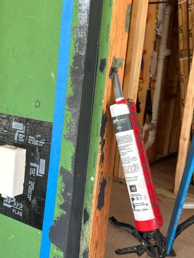 A first pass with fluid-applied fills in nail holes and the joint between the sheathing and framing. 
