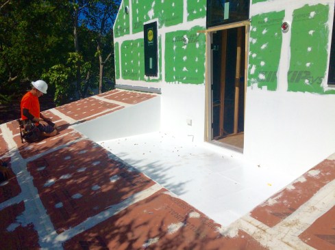 Poor design by the architect for an outdoor roof deck, but if anything will solve this, liquid flashing is a good bet.