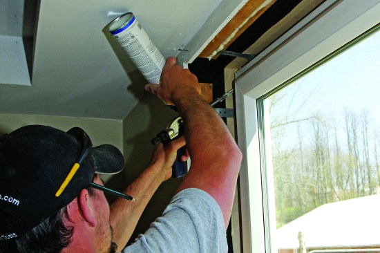 The carpenter has inserted the gun’s tip deep into the gap, so the cavity fills from the back forward as the foam expands. Finally, the carpenter turns the corner and works down the left side.