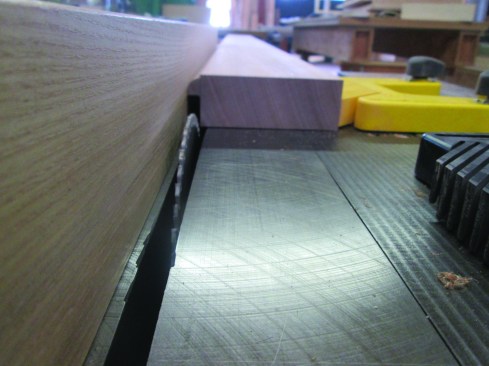 To accommodate small discrepancies in the cut, he leaves 1/32 inch of material on the door, so he has room to adjust later when cutting his jack miters.