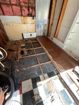 Over the years, this room had numerous floor coverings, including vinyl, slate, an old linoleum tile, and the original plank subfloor.