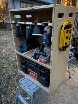 Cases organize tools by category; this one is for corded tools with an attached outlet hub.