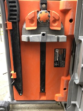 Cross-cut guide and push stick storage are typical. Push stick is easy to reach.