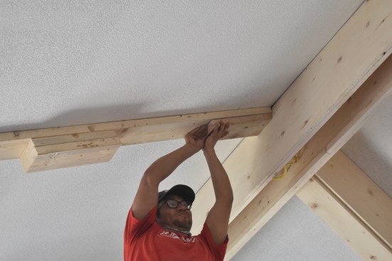 On the ceiling, 2x6 blocking is installed to the backing with close attention to the layout lines.