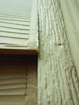Fiber-cement boards shouldn't be butted up against the trim, but should be left 1/8 inch short to allow for expansion. Th gap will allow for a caulk joint that will expand and contract with dimensional changes in the siding boards. Without the gap, you get a flat strip of caulk that is prone to peeling off.