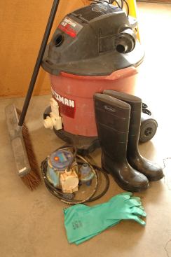 The bare bones, first-response flood clean up kit: Sump pump, wet vac, push broom, muck boots, durable rubber gloves. Not shown are vac and pump hoses, goggles, mask, and other basic personal protective equipment.