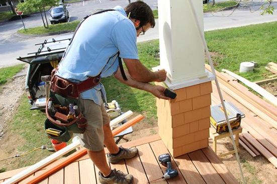 With the columns wrapped and ready, Mark Pollard makes a layout mark for a railing at the center of the post.