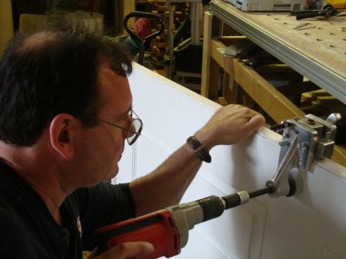 Greg Burnet prepares a door slab in his shop. The slab will be set into a frame all prepared and preassembled in his shop for maximum quality control.