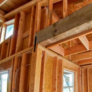 Walls are strapped together under the beam, but the beam needs to be strapped to triple 2x6.