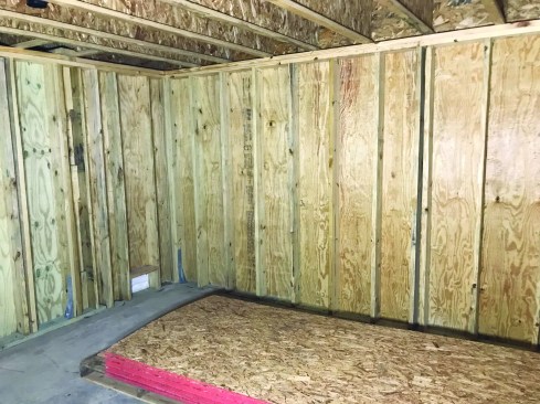 The space’s 8-foot walls are detailed as shear walls for windstorm resistance, including 4-inch-o.c. nailing and beefy hold-downs.