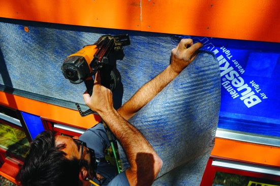 Then he used a cap-nail gun to fasten MortairVent drainage fabric to the wall. The MortairVent would create a 3/8-inch air gap behind the wall’s preprimed cedar clapboard siding, helping to prolong the building’s paint job.