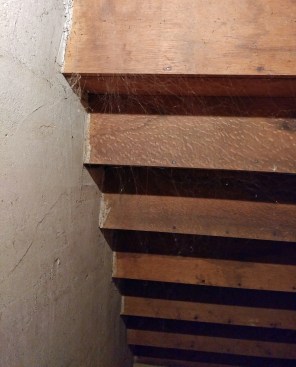 On the open sie, the finish stringer, which is also the carriage, is supported by a flat-framed wall tied together with oak laths and plastered on both sides.
