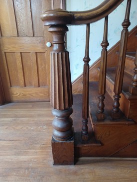 The pedestal is braced by the stringer and the first tread and riser and locked in by finish flooring.