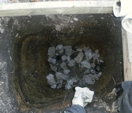 When I reach our local frost depth of 48 inches, I add about 6 inches of stone to the bottom of the hole.