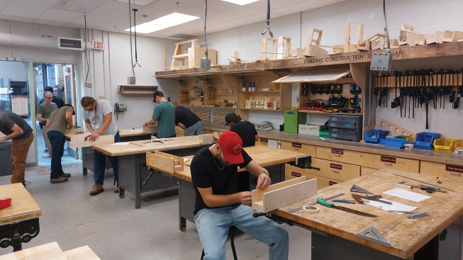 Starting with hand tools and bench skills, students work up to larger projects as the levels progress. Here, the students are making miter boxes (above). Wall layout and framing is being practiced by the level 2 students in their teams (left).