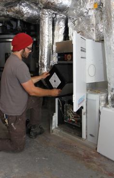 This design uses a gas boiler and solar thermal collectors as heat inputs, and incorporates an HRV into the air handler.