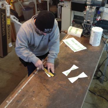 Next Manny cuts the angles to form the bow ties. The widest part of the tapered cut starts at the fold.