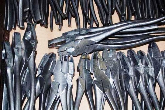 Assembled linesman pliers after finish grinding.