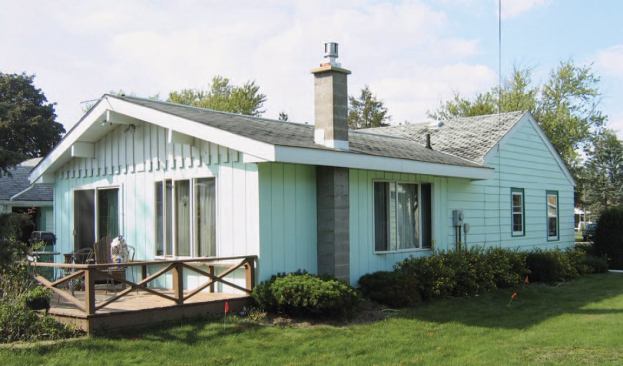 A 1970s addition off the back added much-needed square footage but suffered from the same poor energy performance. In addition to leaving the siding exposed to rain and weather, the absence of eaves overhangs in the front created a visually awkward transition to the broad eaves in the rear.