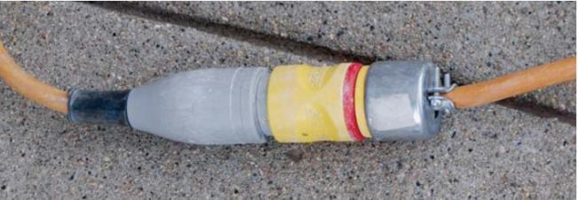 The Qwik-Lok fitting on the female end of this extension cord connects to the male end of the tool plug, eliminating the need to knot cords together.