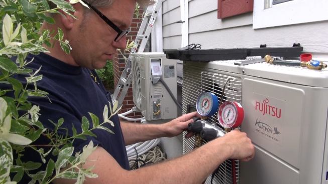 ReVision Energy master plumber Dave Ragsdale examines pressure gauges connected to the refrigerant lines of a 12,000-Btu Fujitsu mini-split heat pump. The refrigerant lines operate at about 400 psi of pressure; Ragsdale is testing the system at 600 psi.