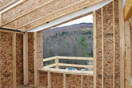 A framed opening for a large south-facing window. South-facing windows will supply solar heat gain in winter and also provide a pleasing view of the nearby hills and ski slope to the south.