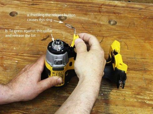 Pull out spring-loaded accessory release button (you load bits by pushing them into the chuck; to get them out you must push this button).