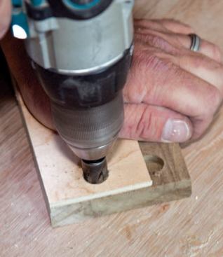 He cuts a wood plug.