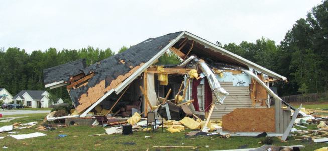 Though this home's roof remained largely intact, several of the exterior walls were blown out — a testament to both the tornado's lack of strength and the inability of poorly executed framing connections to maintain integrity of the building envelope.