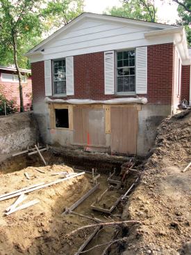 The footing below the patio door was dropped almost 4 feet to reach below the frost line; a one-sided form was used to pour that section of the foundation.