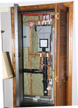 The author converted a basement closet into a small mechanical room with insulated walls and a secondary solid-core door to block noise.