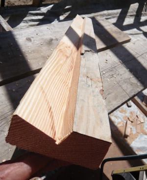 The blocks were ripped so they could be caulked into place, bearing solidly on the glulam beam and matching the angle of the rafters to provide a caulkable nailing surface for the sloped ceiling drywall.