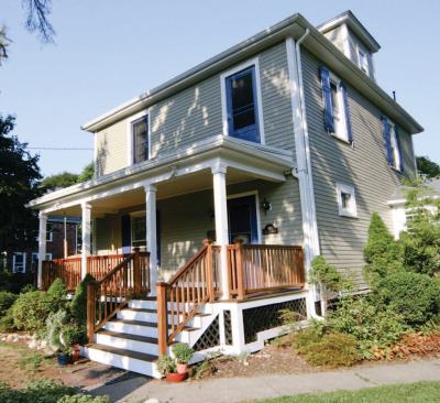To reduce maintenance costs, the homeowners opted to replace the weathered cedar shingles with new factory-painted fiber-cement lap siding.