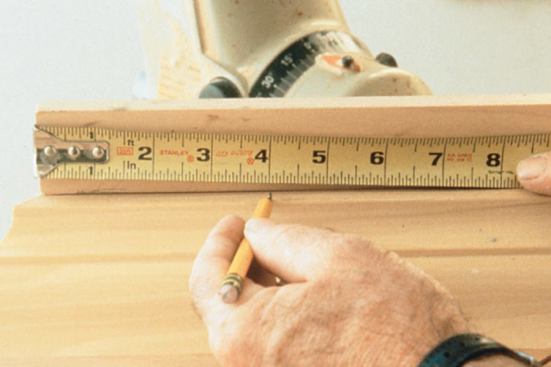 Measure an outside corner by aligning the short point with the edge of the saw fence and hooking the tape over the fence.