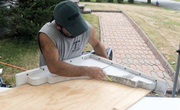 After carefully removing the brackets, we used one of them as a template, first tracing its profile onto a scrap of plywood, then cutting it out with a jigsaw and sanding it smooth.