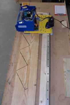 The Handibot is shown here cutting out a stair stringer. To keep the waste pieces from coming loose and possibly jamming up the machine’s movement, small tabs of material are left in the kerf so the pieces can be separated after the machine finishes its cutting path. [27] ShopBot’s stationary Desktop CNC machine is shown roughing out a violin back. When the board is flipped over, the machine will rout out the inverse of the profile, leaving a very thin curved piece of even thickness.