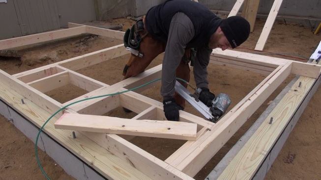 Hill completes the framing of the ground-level window’s rough opening.