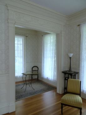 On the other side of the room a smaller doorway uses the same column detail as the casing along the sides of the opening.