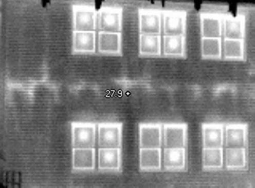 Voids in the insulation are clearly visible in the band-joist area of this two-story home. The characteristic "bull's eyes" on the window glazing are an early indication that the inert gas fill has become depleted, allowing the double panes to squeeze together near the center. IR can readily detect this problem — which is otherwise difficult to spot — and enable a builder or homeowner to make a claim with the manufacturer before the expiration of the window warranty.