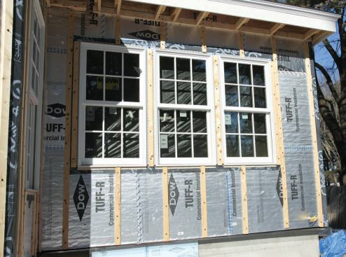 The sheathing is strapped on 2-foot centers, directly over the wall framing. The top of the venting channels is open to the soffit, ensuring positive airflow from the bottom up.