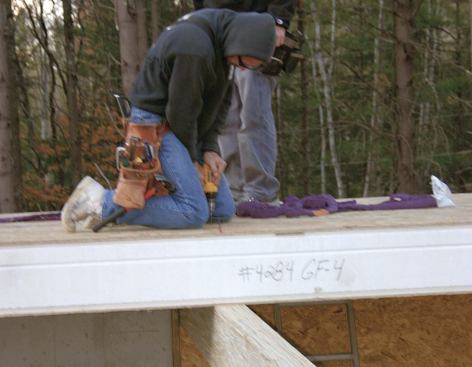 Panels are fastened to bearing beams with epoxy-coated self-tapping screws.