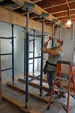 Undermount beam. Prior to removing the old undermount beam, the crew erects shoring on each side of the opening.