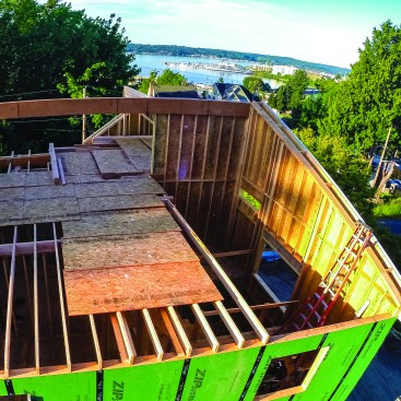 Then a two-story balloon-framed wall was installed below the ridge.