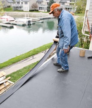 Glue is applied to the seam tape. Although the tape is self-adhering, the author uses glue as an extra precaution.
